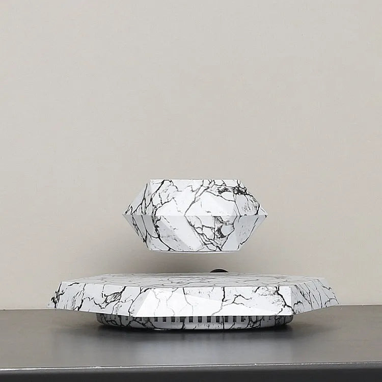 Marbled levitating plant pot floating in air with small plant under soft light
