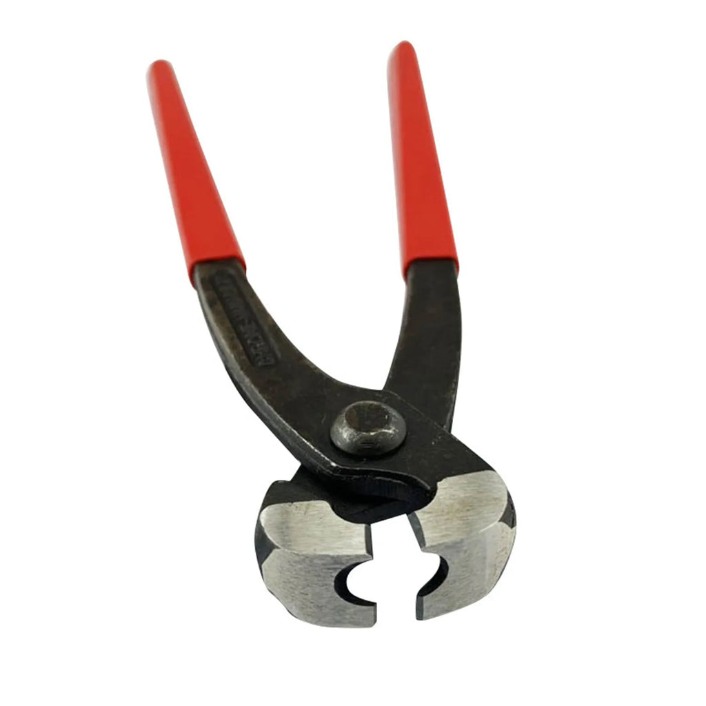 Red coloured metal single ear clamp tool set with carbon steel cutting edge on a workbench.