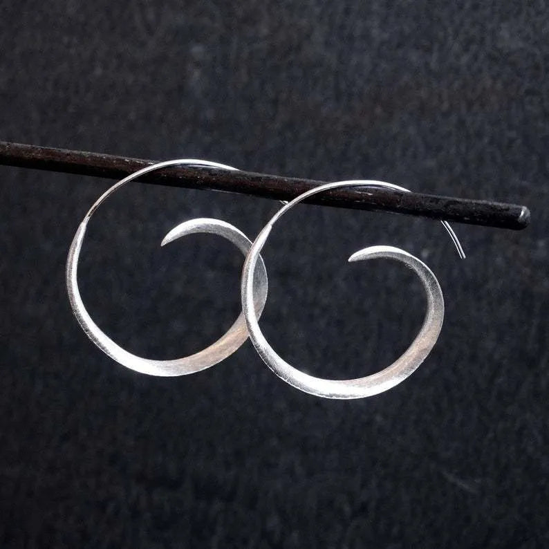 Round alloy ear studs with spiral leaf design in gold electroplated finish on white background