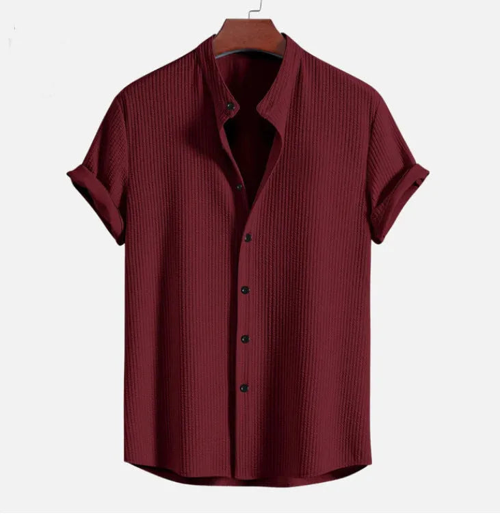 A loose-fitting men's short sleeve casual shirt in a light blue colour, laid flat.