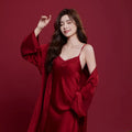 Red silk pyjama set for couples with long sleeves and trousers, shown in men's and women's matching styles