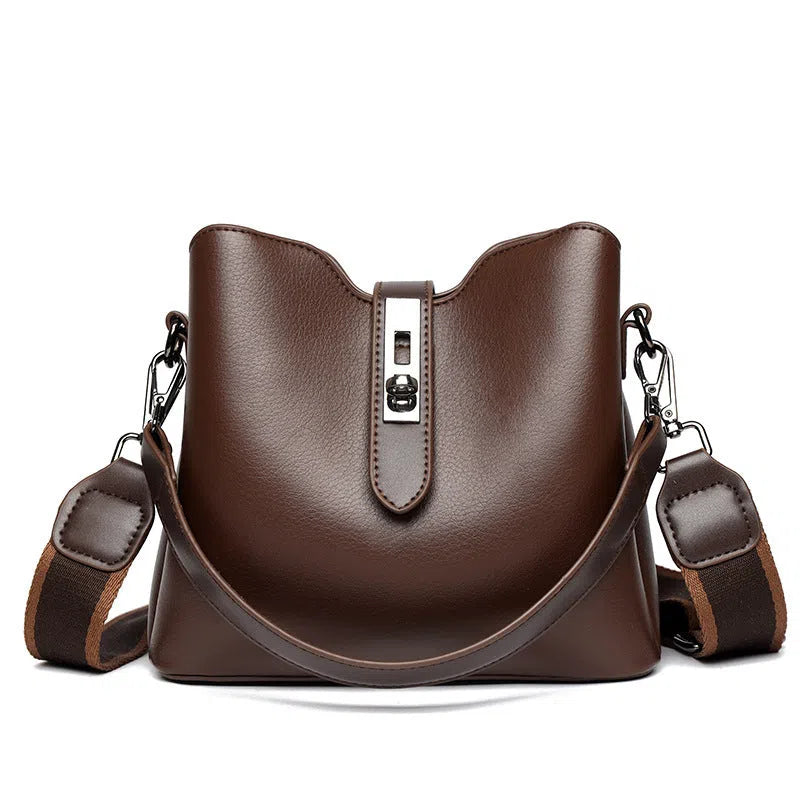 Textured PU bucket bag in black with patchwork stitching, horizontal rectangular shape, single shoulder strap.