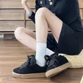 Men's and women's black retro low-top sneakers with waterproof platform rubber sole and front lace-up closure