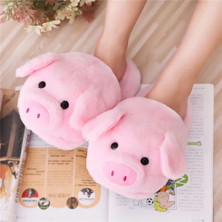 Pink pig floor slippers with plush lining shown on clean indoor surface