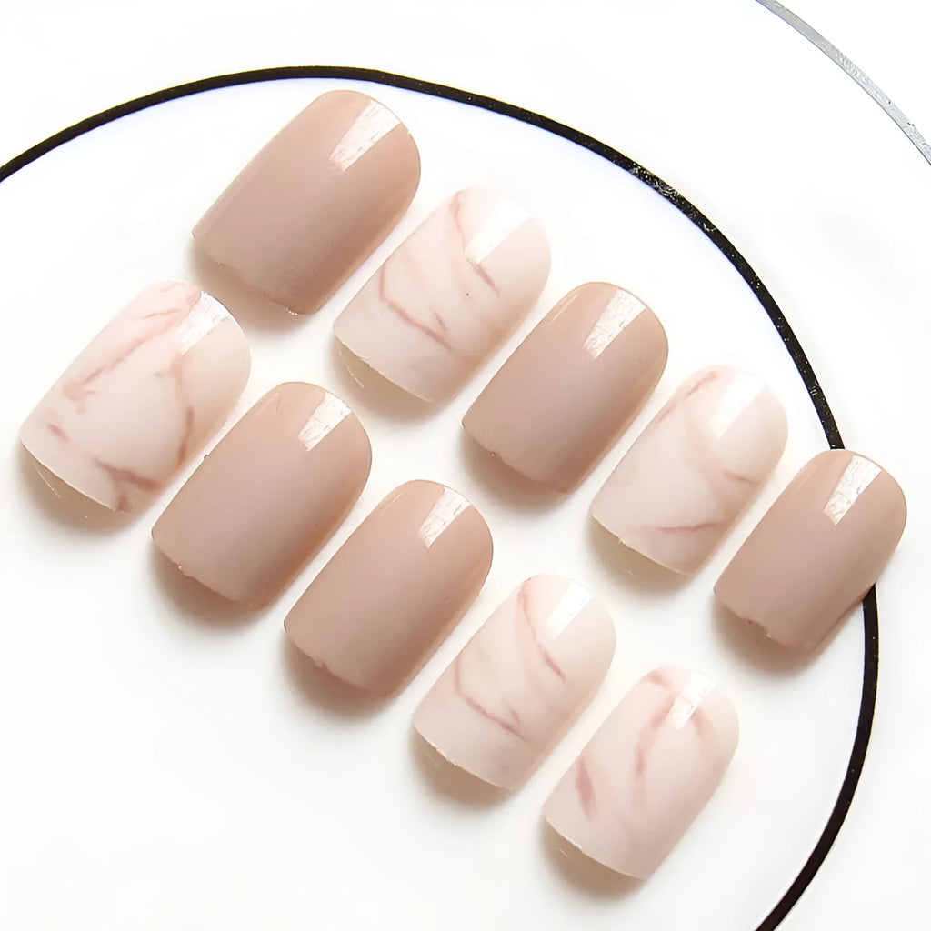 24 light khaki smudge false nails with glue in almond shape on white background