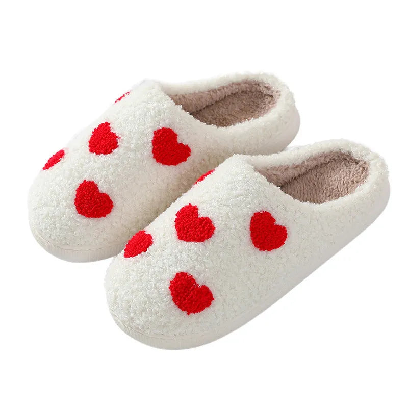 Women's plush cartoon love style home slippers with a round toe and non-slip PVC sole.