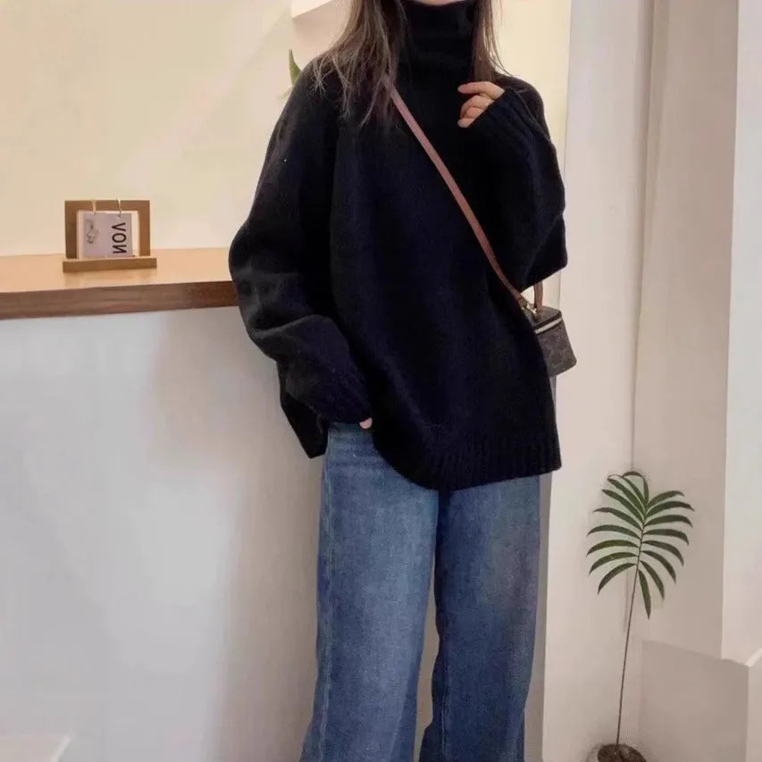 Women's loose grey turtleneck sweater with a thick knit and textured curling pile collar.