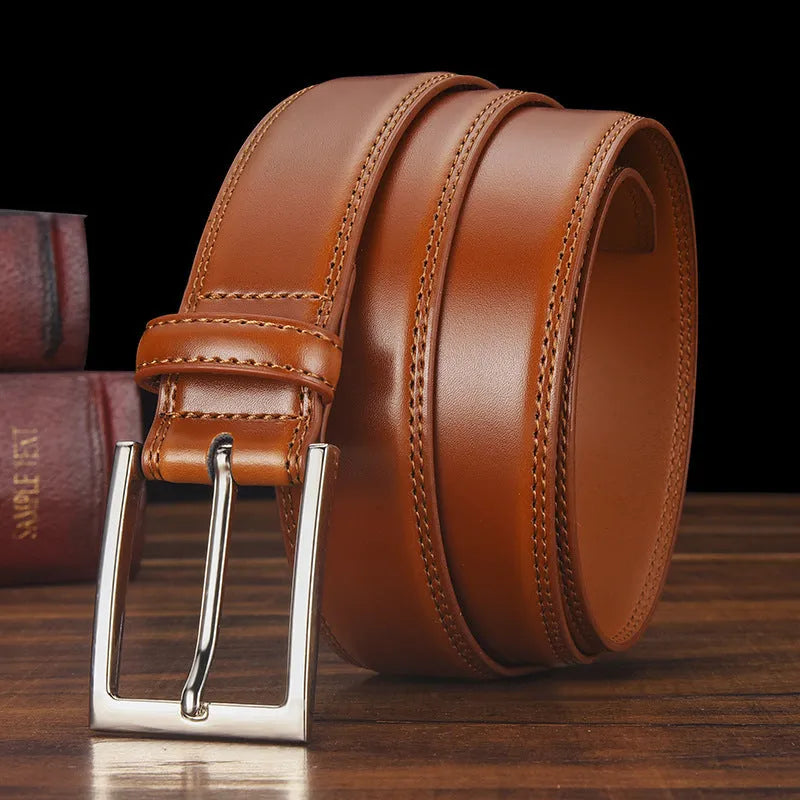 Men's black genuine leather belt with a silver alloy pin buckle on a trouser waistband