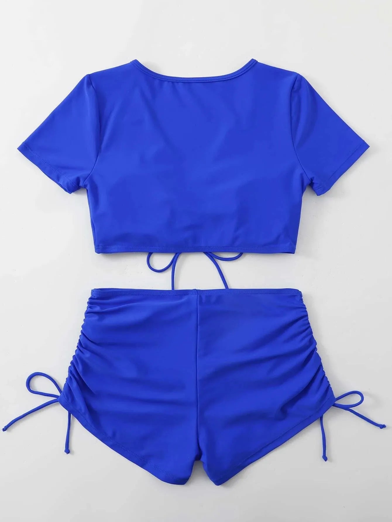 Dark green ladies lace-up bow swimsuit top with matching shorts on a mannequin
