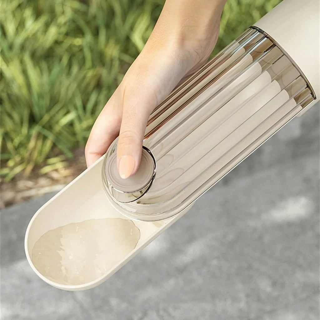 Beige and green foldable dog water bottle with integrated food container at the base