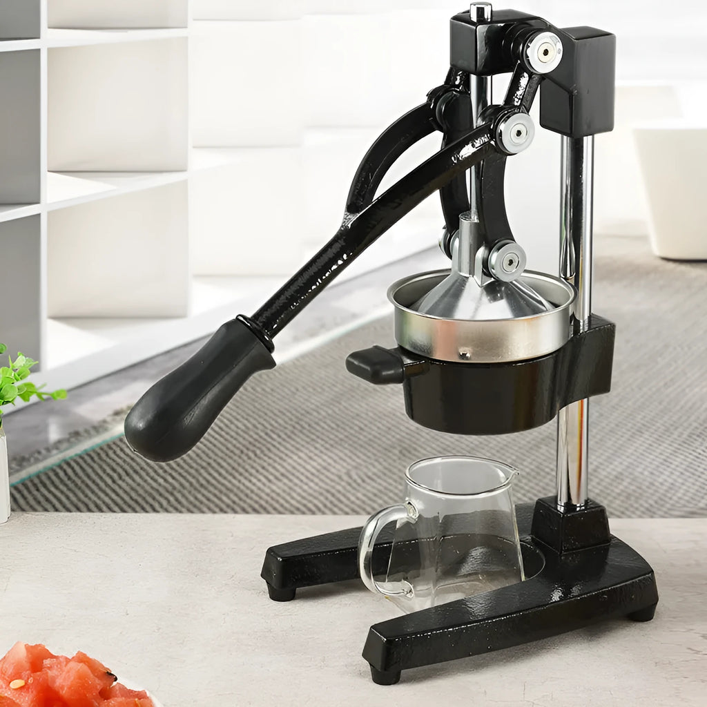 Cast iron manual citrus juicer with stainless steel funnel showing black finish