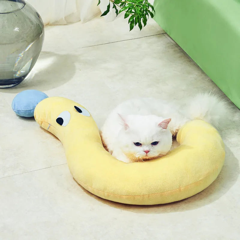 Blue rectangular pet sleeping cushion for cats and dogs on a wooden floor.