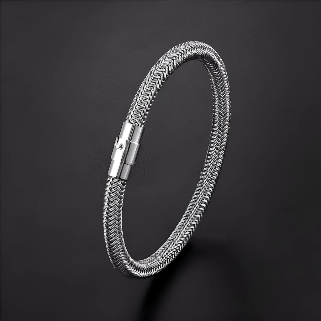 Geometric titanium steel bracelet with magnetic clasp shown in a unisex style on a wrist.