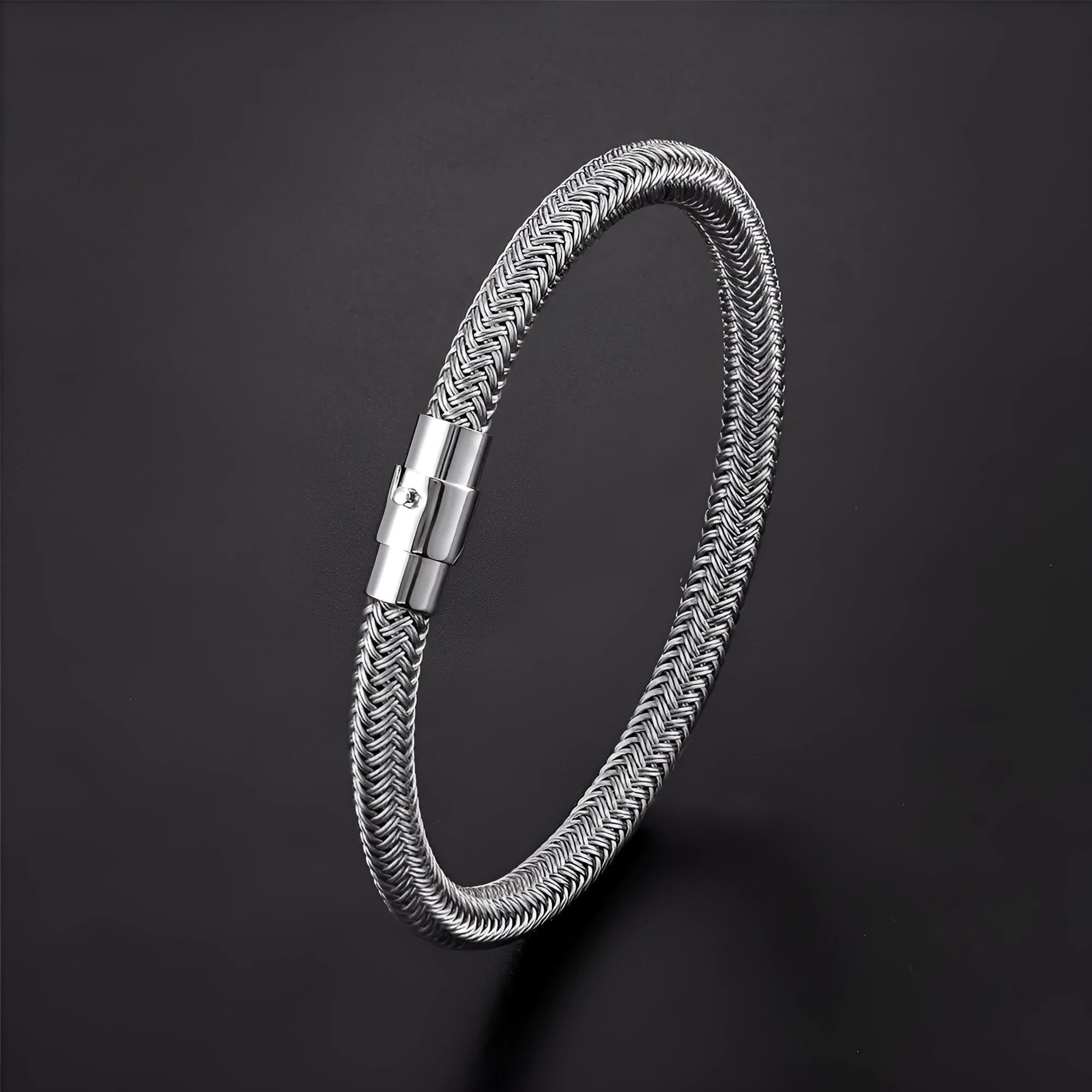 Geometric titanium steel bracelet with magnetic clasp shown in a unisex style on a wrist.