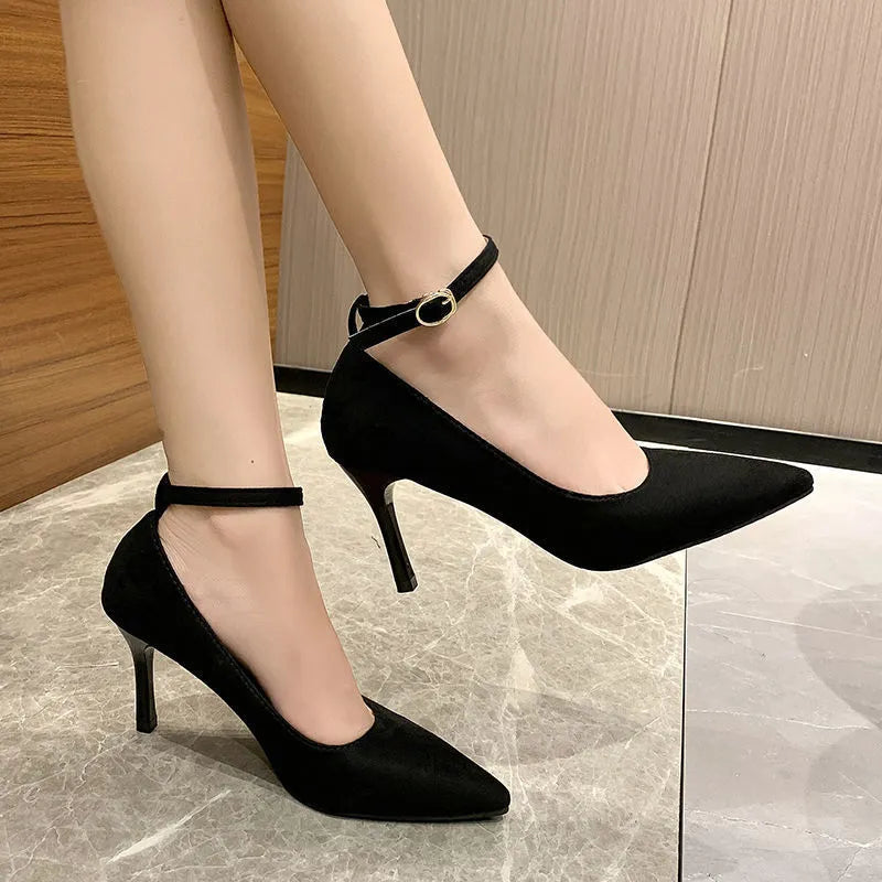 Women's black stiletto heel pumps with buckle detail showing 8cm rubber sole