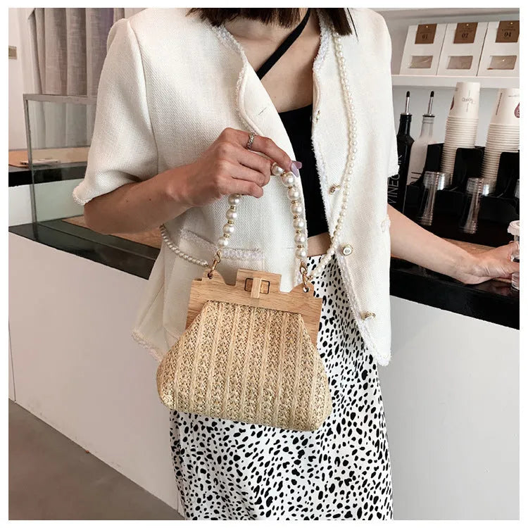 Women's straw woven shoulder bag with beach pearl chain detailing and horizontal square shape