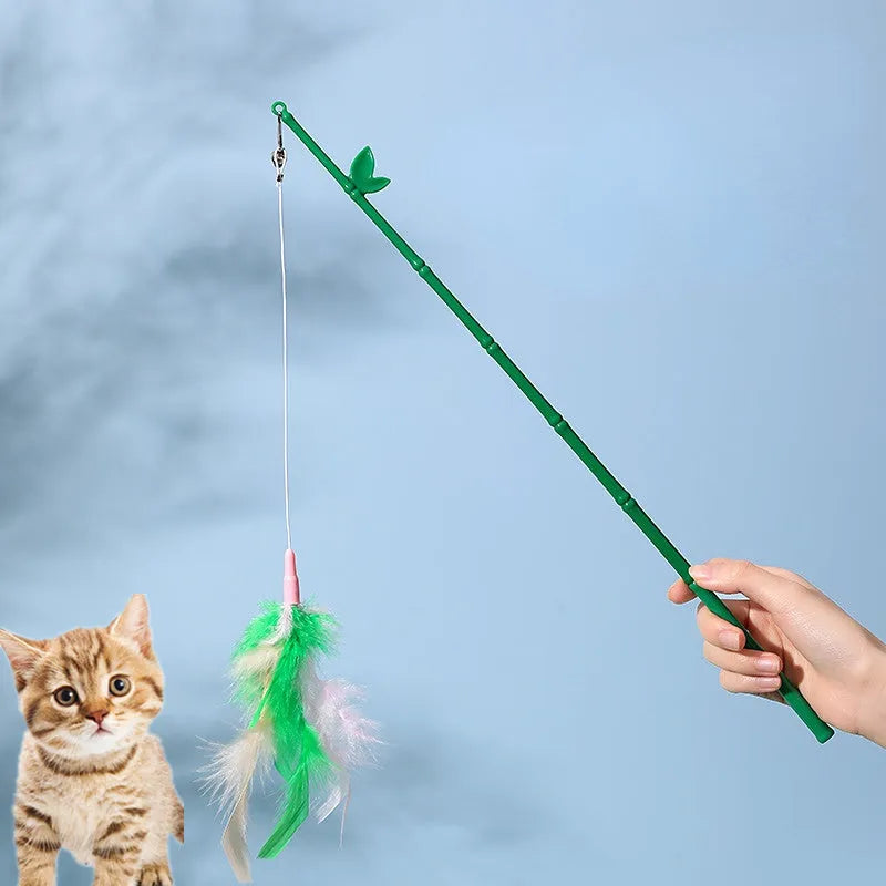 Green interactive cat feather wand toy with bells on a light background