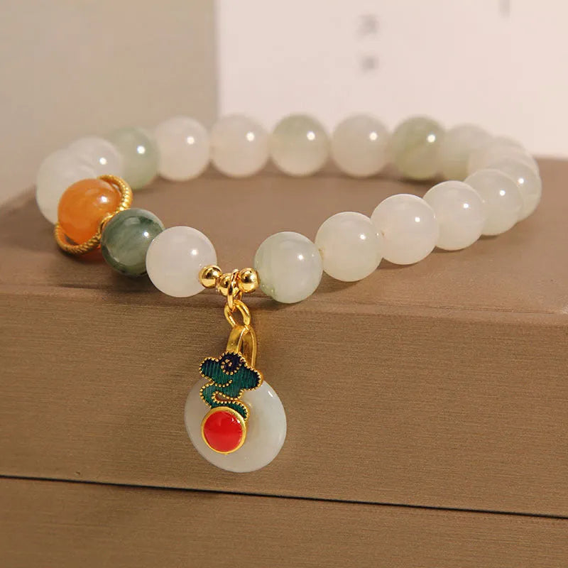 Women's Ice Jade jade bracelet with a Xiangyun peace buckle and pearl details on a white background.