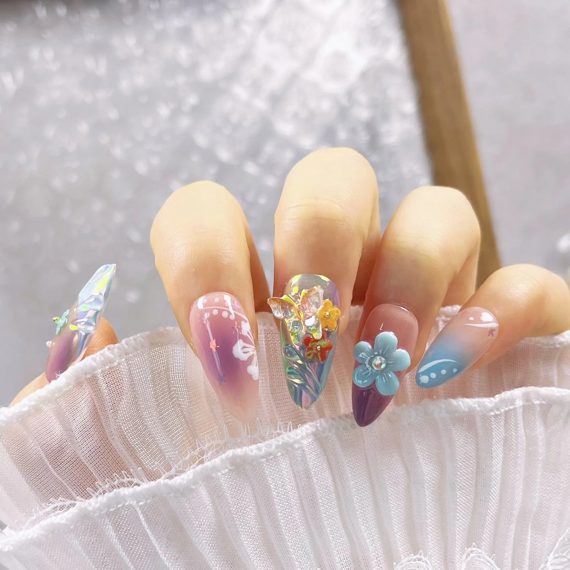 Handmade 3D flower and butterfly nail art sculptures in colourful press-on manicure designs