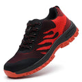 Red low-top safety shoe with mesh upper and visible steel toecap on a neutral background.