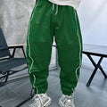 Man wearing loose-fit, cropped-length bamboo fibre sports trousers in a neutral colour.