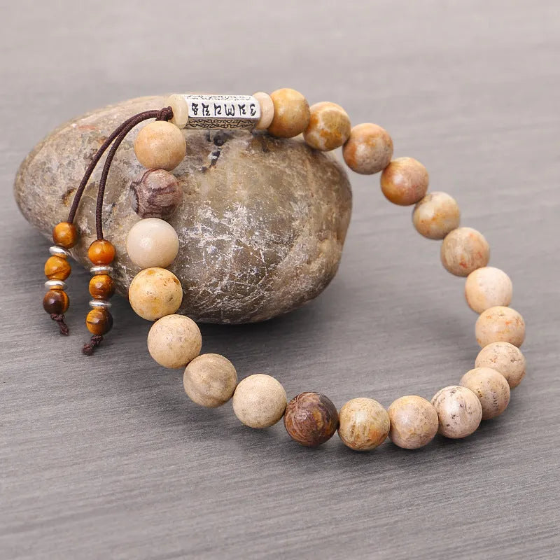 Handmade wood-colour stone bracelet with retro design on a wrist.