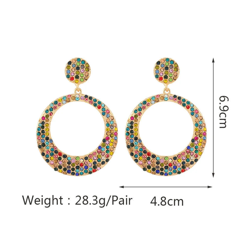 A pair of large round colourful alloy pendant earrings with a cartoon style on a white background.