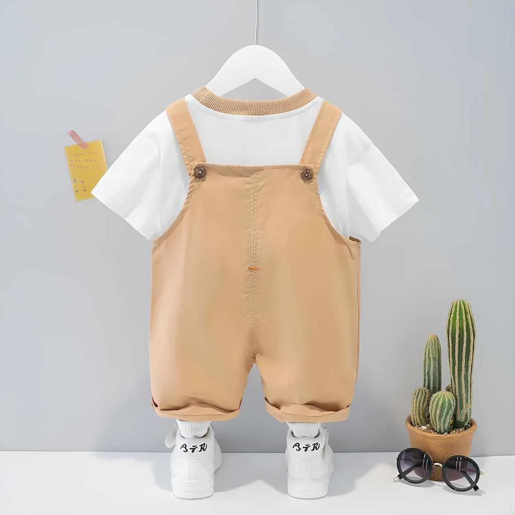 Baby wearing yellow cotton summer overalls with cartoon design, short sleeves, and adjustable straps