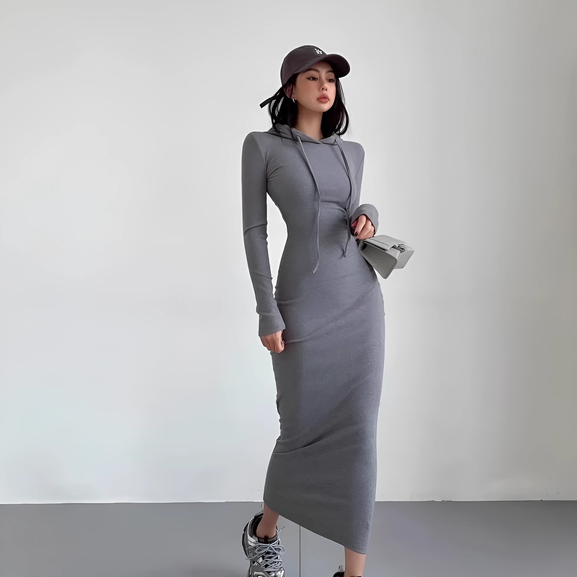 Women's grey hooded long-sleeve sheath dress with a high waist on a model.