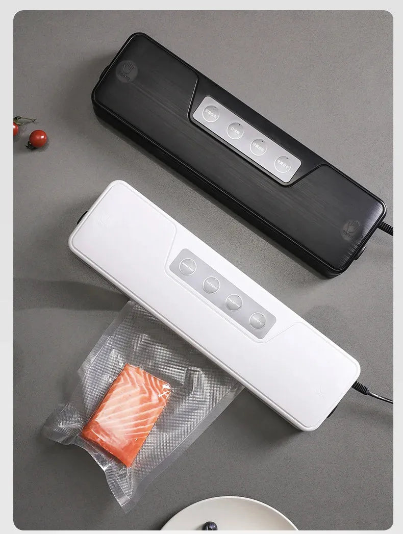 White automatic vacuum sealer machine for household food preservation on a kitchen counter.