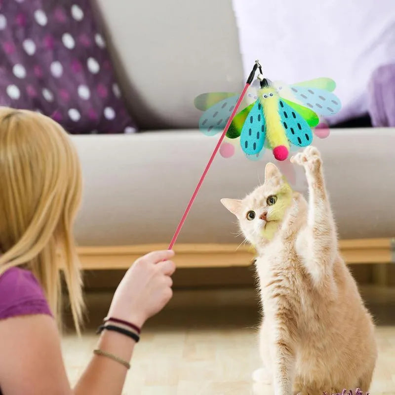Cat wand toy with bell and dragonfly attachment in green, ABS stick 49cm long, on a light background
