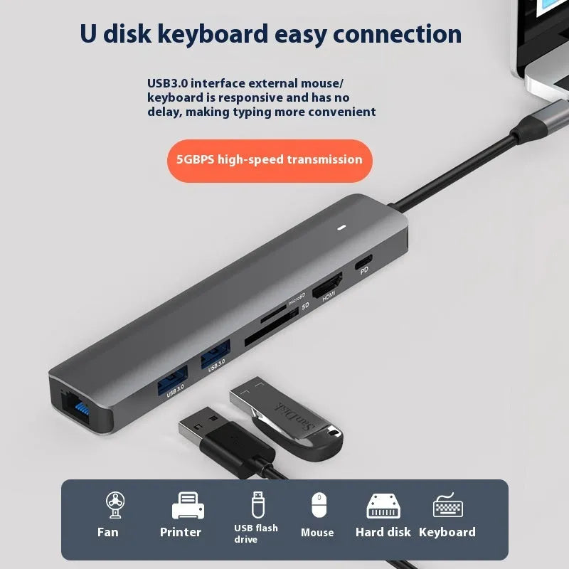 LQT-LH07 seven-in-one USB C hub and card reader adapter for laptops on a desk.