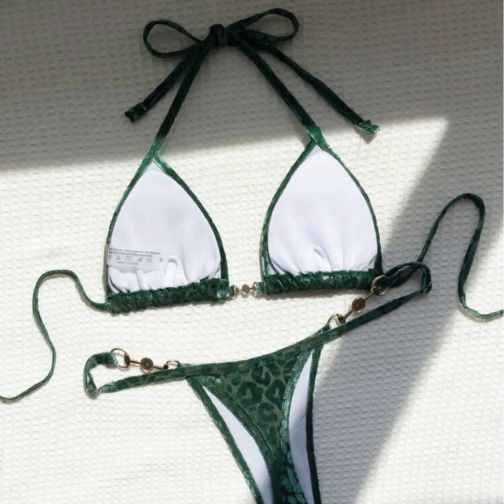 Women's blue leopard print bikini set on a yellow background, showing triangle top and briefs style.