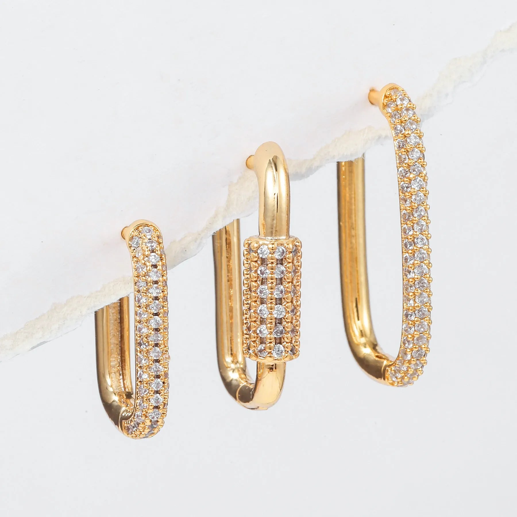 Three geometric earrings with micro inlaid zircon on square clips in gold and white finishes