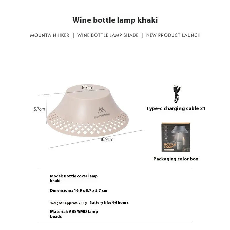 Beige wine bottle shaped camping lantern with USB-C port, shown lit on a wooden table outdoors.