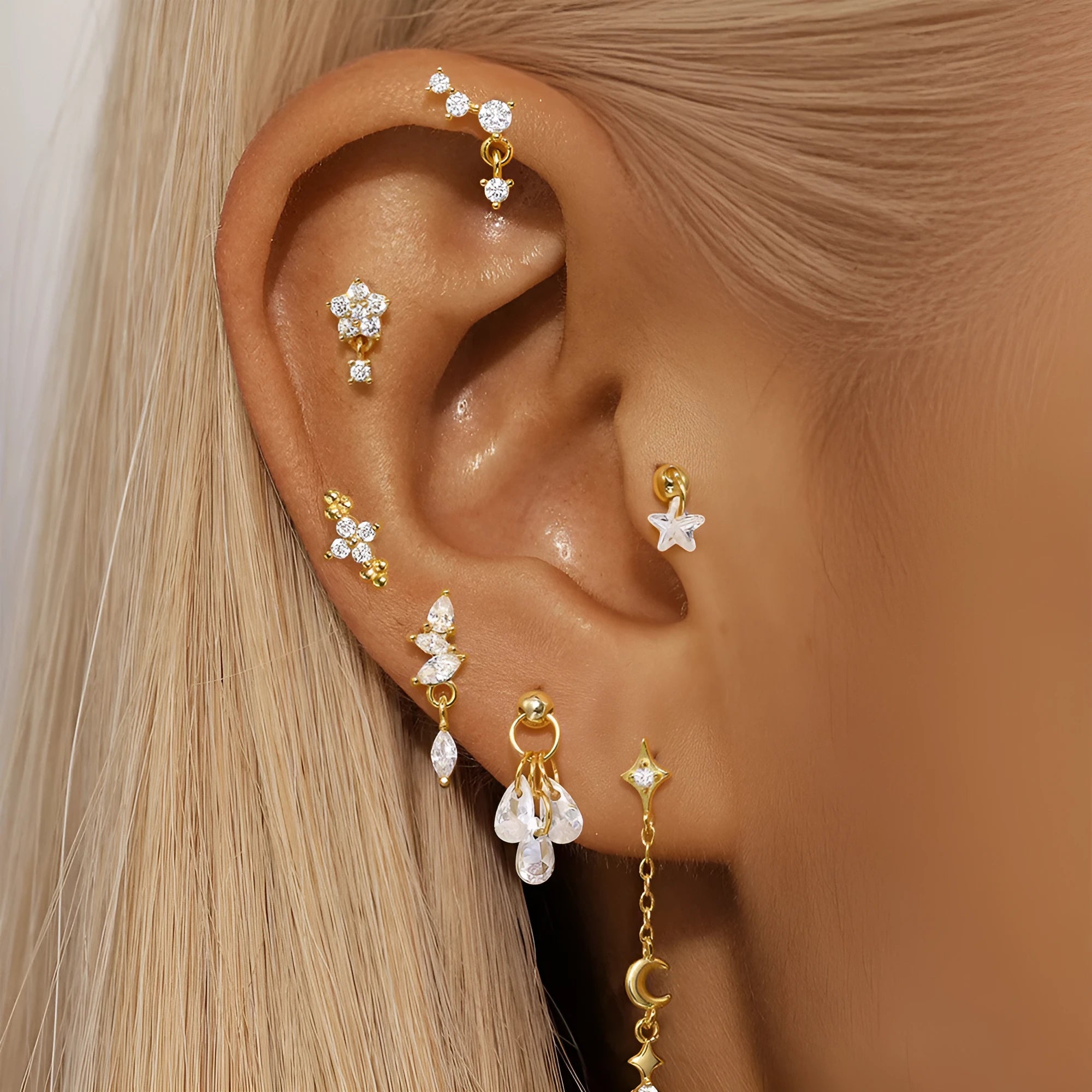 S925 sterling silver geometric stud earrings with moon shape and diamond-embedded star detail in a gold tone.