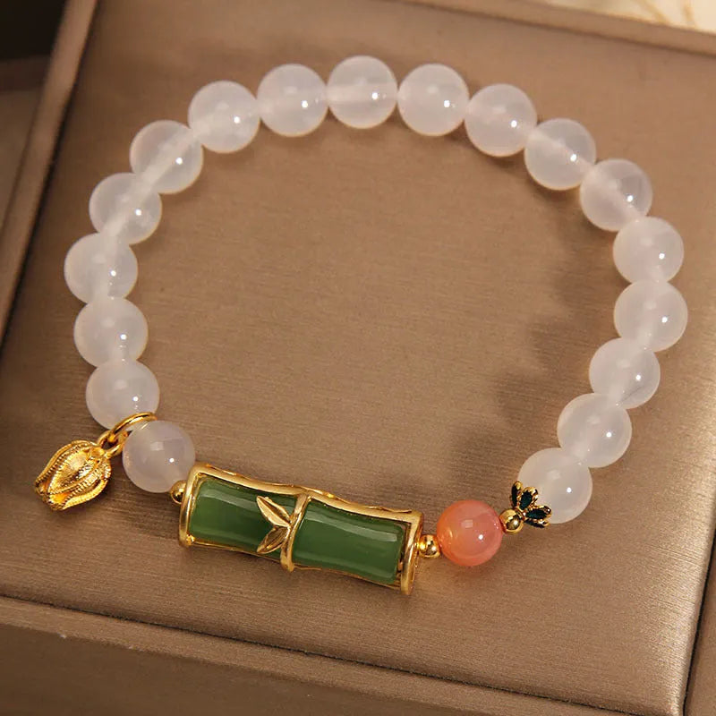 White agate and jade bamboo beaded bracelet on wrist, natural stone jewellery for women