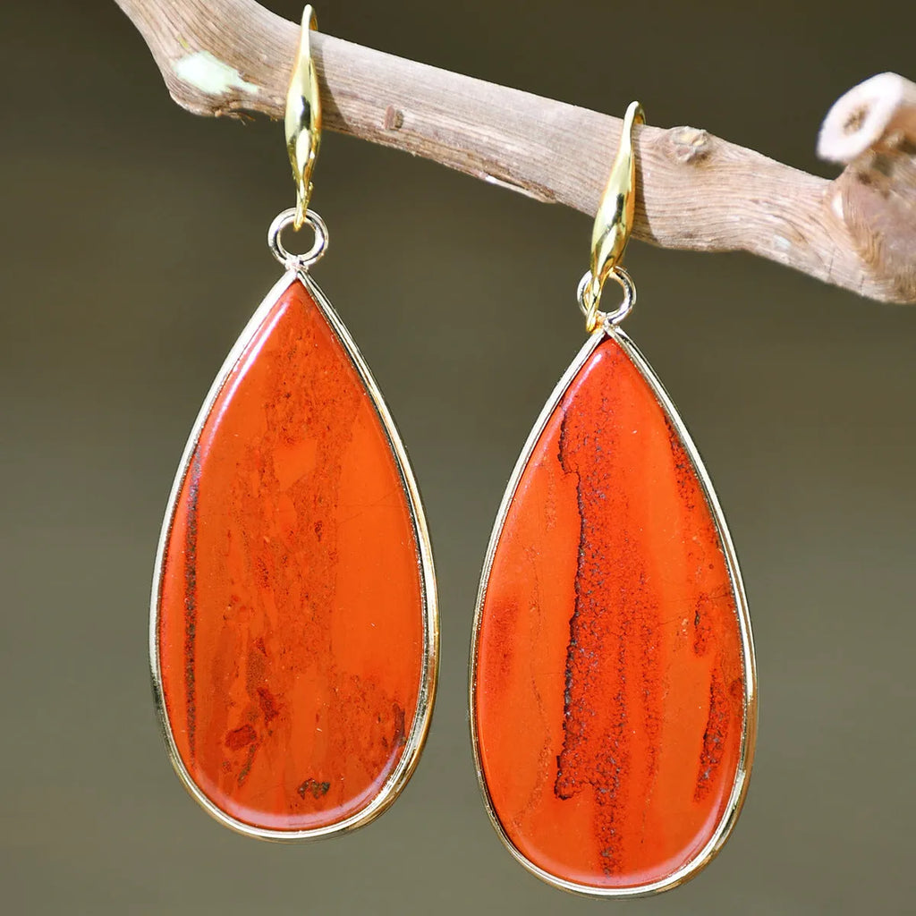 Vintage long water drop earrings in natural stone with textured surface and retro style