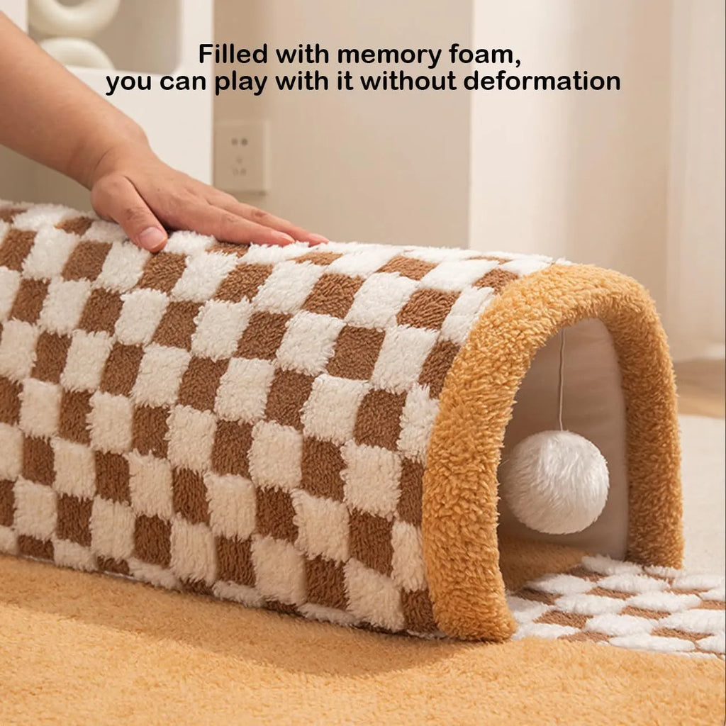 Coffee-coloured plush pet bed with attached tunnel showing soft sleeping area and play space
