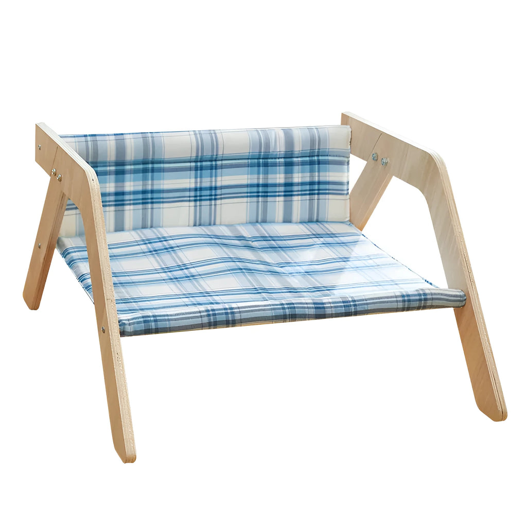 Elevated wooden cat bed with blue cloth hammock surface on a wooden floor