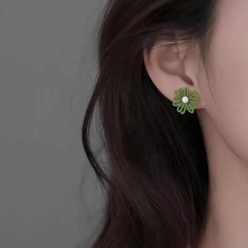 Cartoon-style flower alloy earrings in blue and orange, white and green, and yellow and white two-tone colour options