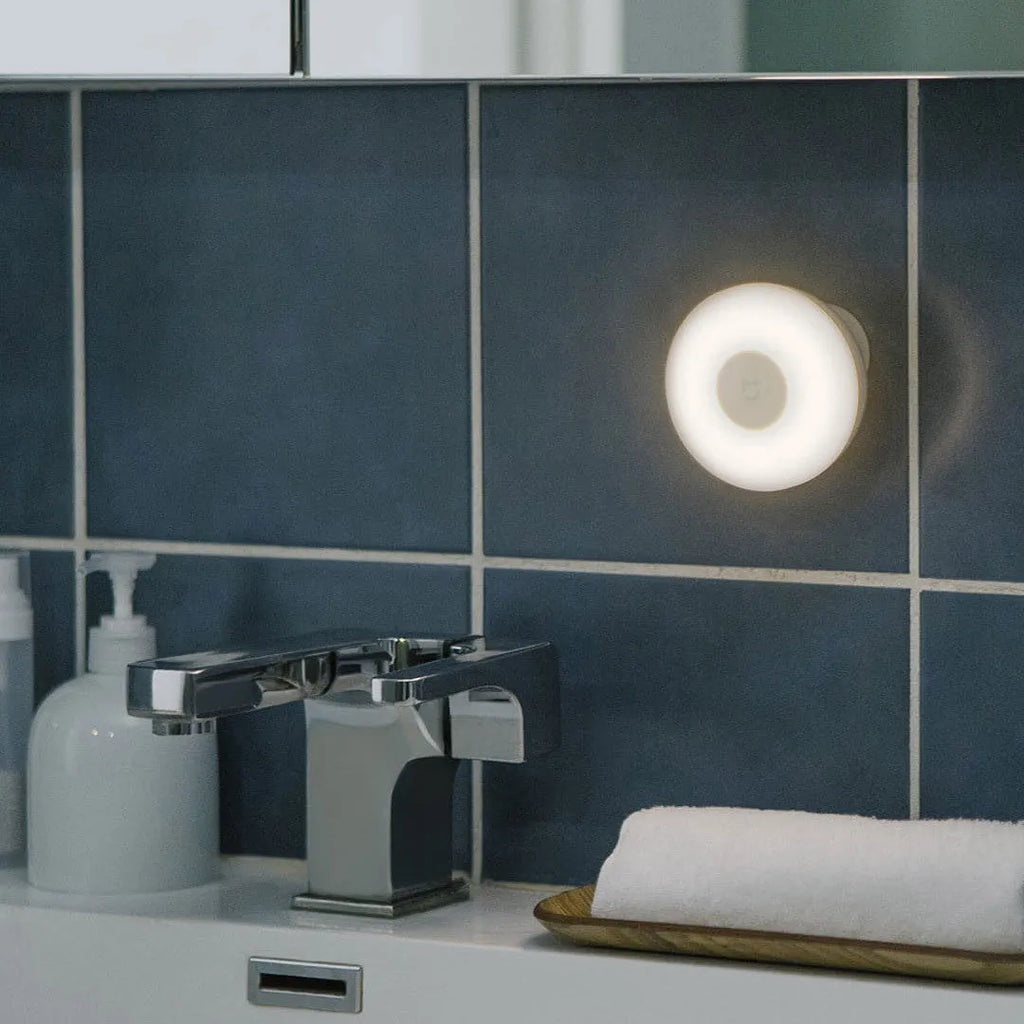 White modern bedside table lamp with human body induction and Bluetooth connectivity.