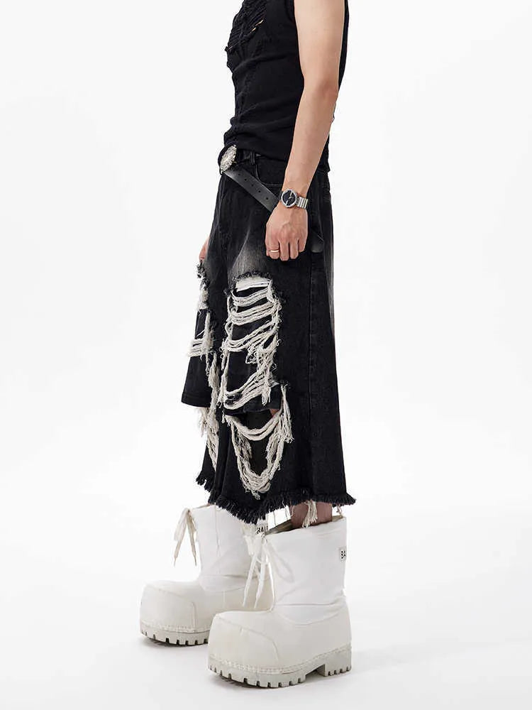 Black cropped wide-leg women's jeans with ripped patch detail on the knee.