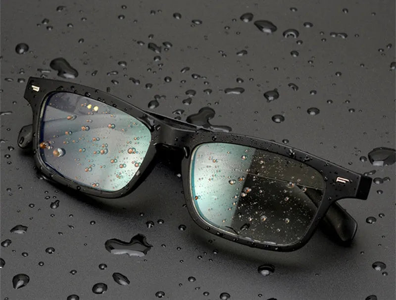 Smart glasses with tinted lenses and open-ear Bluetooth speakers on the temples.