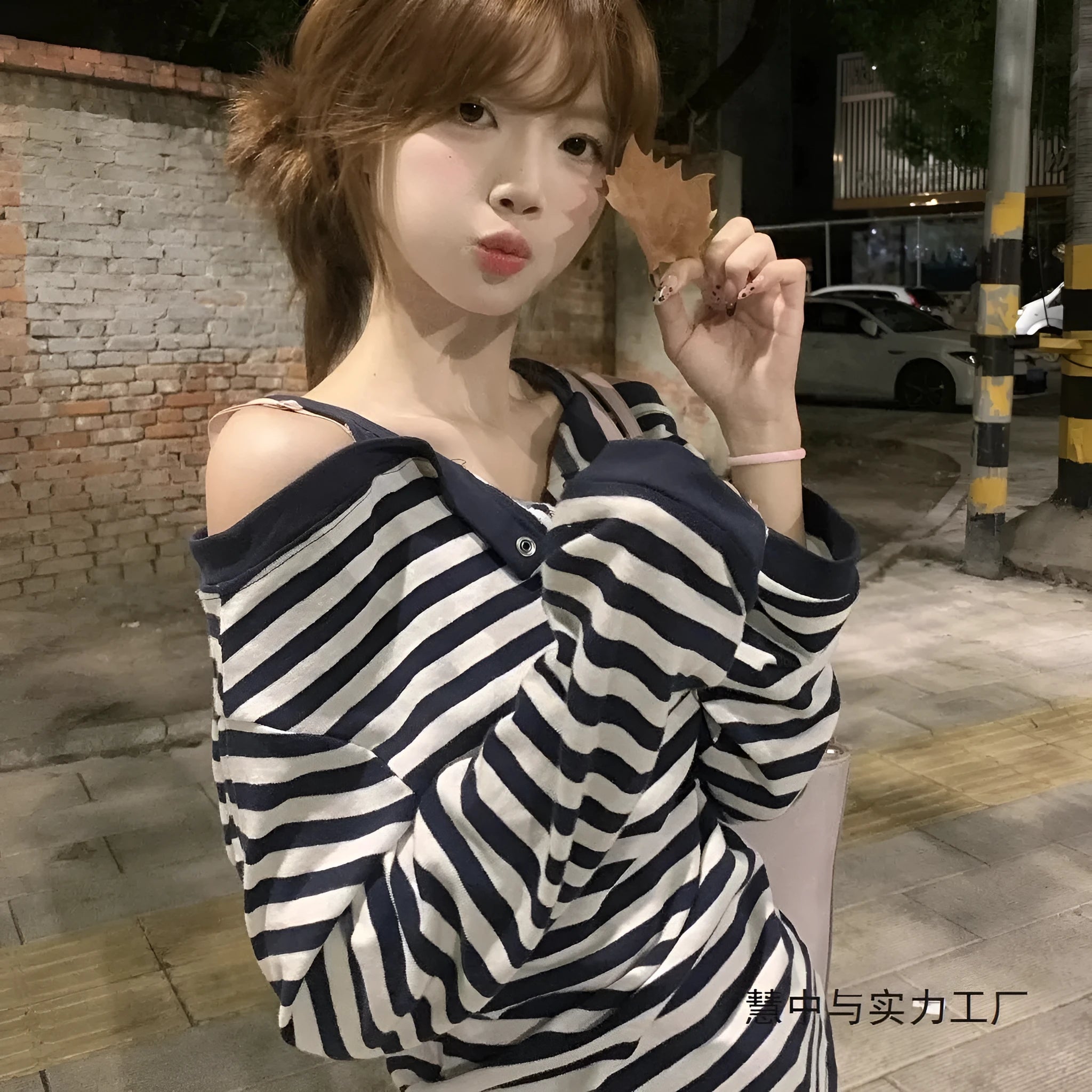 Dark blue Korean-style oversized women's T-shirt with embroidered stripes and button details on long sleeves