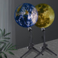 Earth and Moon projection lamp with flexible hose bracket on a bedside table