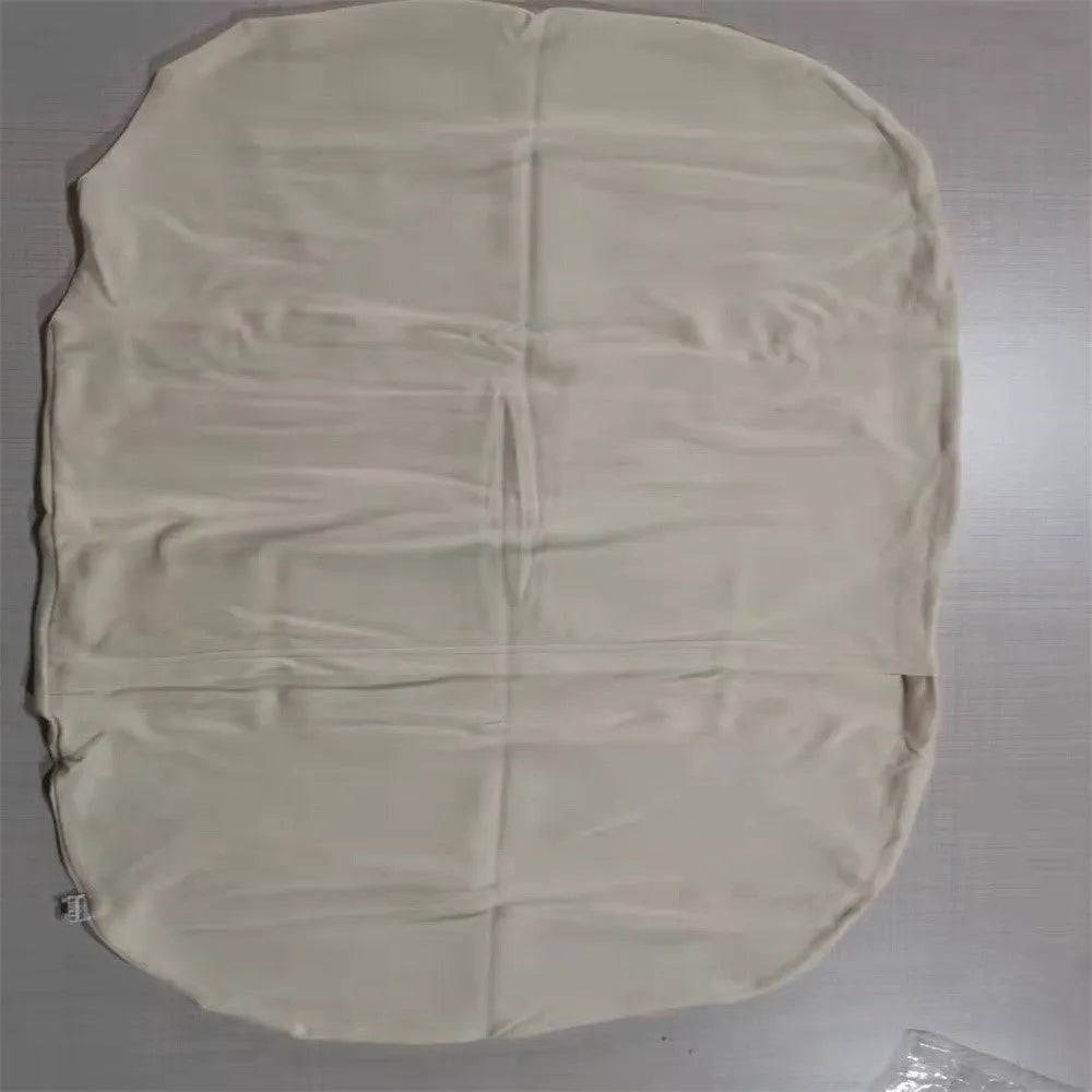 Beige portable baby nest cot cushion measuring 75cm by 45cm on a floor.