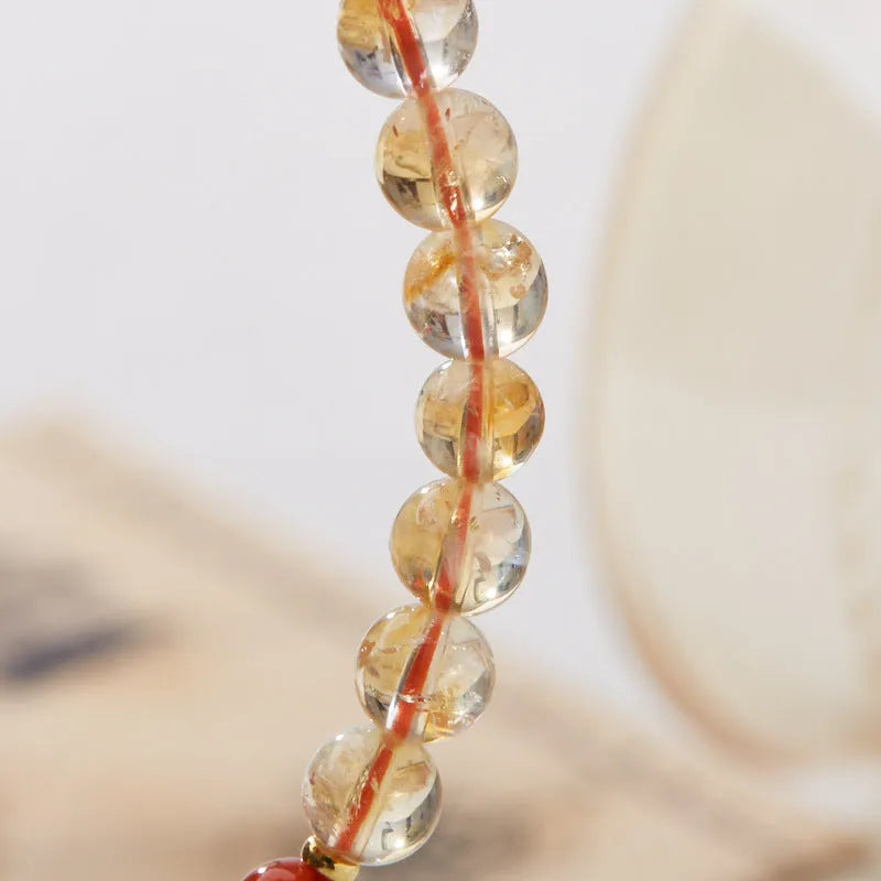 Citrine five sutra hand-woven crystal bracelet with geometric design on neutral background
