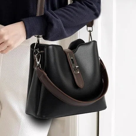 Textured PU bucket bag in black with patchwork stitching, horizontal rectangular shape, single shoulder strap.