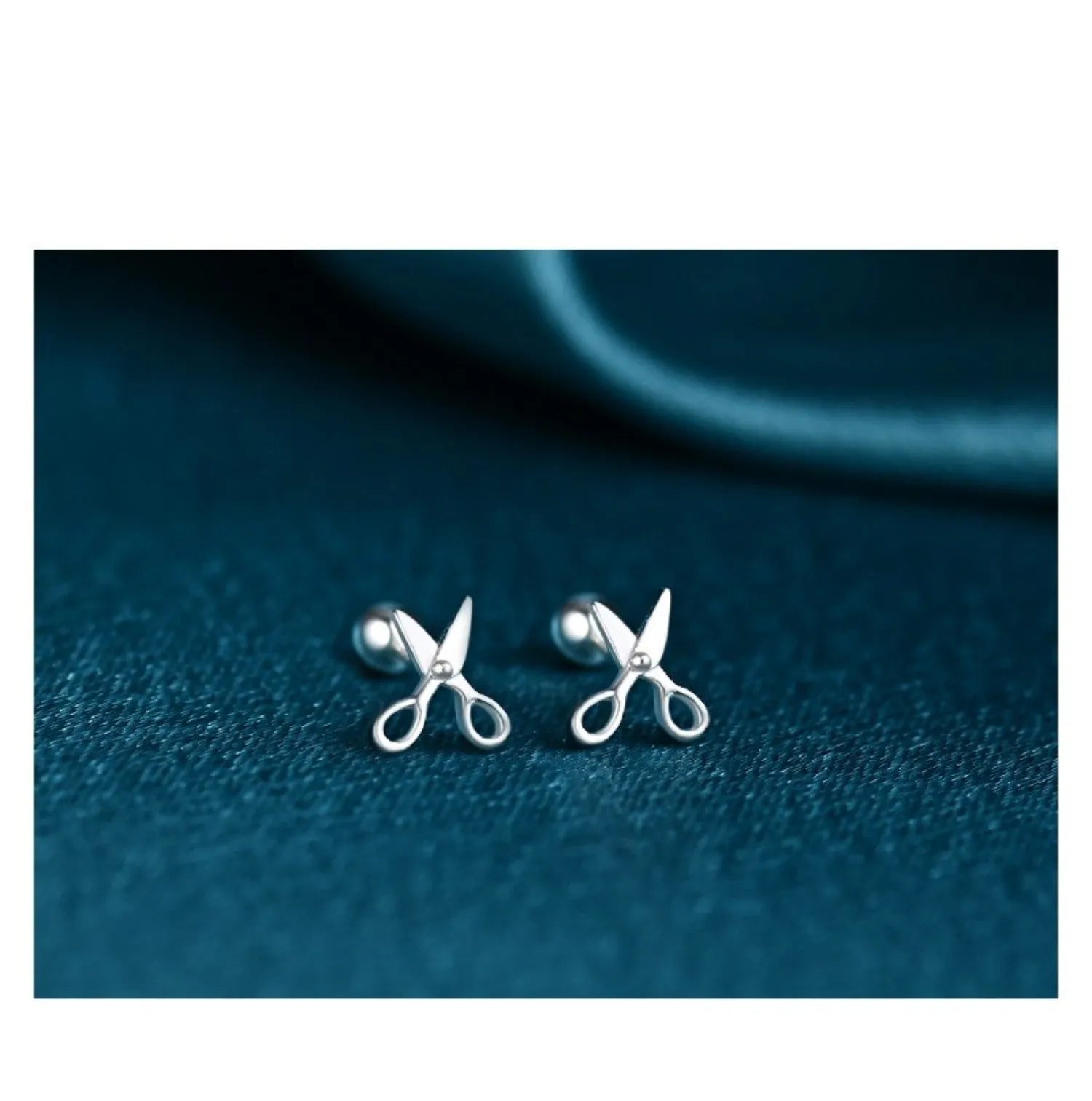A pair of pure silver ear nails with a miniature scissors screw fastening mechanism.